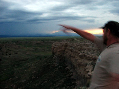 Steve chucking rocks off of a bluff