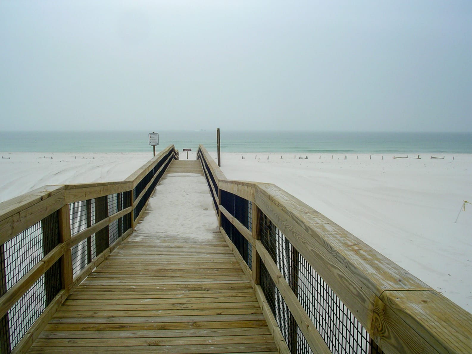 A boardwalk to a cold beach and ocean