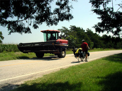 Steve riding next to some dangerous farm equipment
