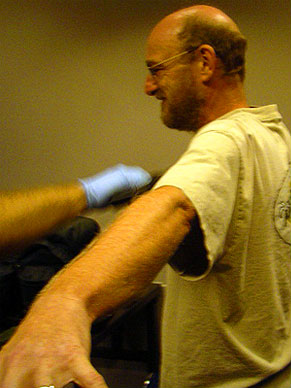 Steve being checked for explosives and weapons at the airport