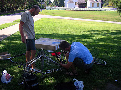 Shannon dismantling Steve’s bike while Steve supervises